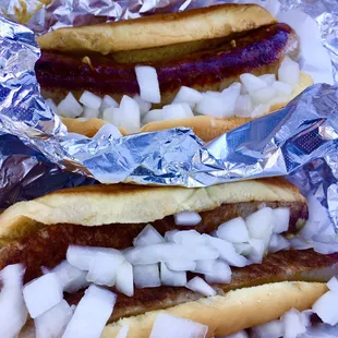 two hot dogs with onions