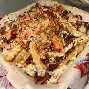 Lobster French fries with bacon bits  Looks delicious but sauce was bland and lobster was cold with warm French fries