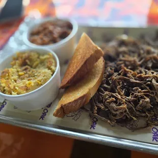 Brisket platter with baked beans and hog feed