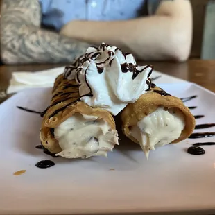 a banana split with whipped cream and chocolate sauce