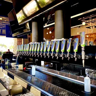 a row of beer taps at a bar