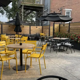 a patio with tables and chairs