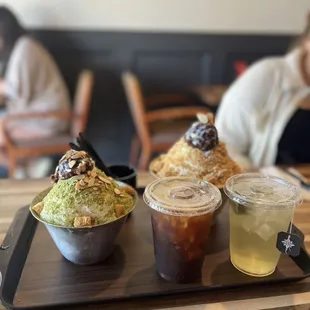 a tray of desserts and drinks