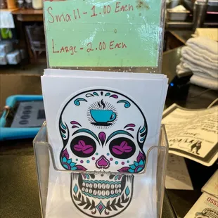 a skull with a cup of coffee
