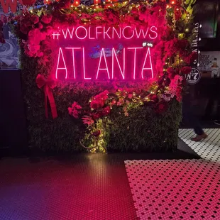 a neon sign that reads wolf knows atlanta