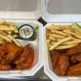 two trays of wings and french fries
