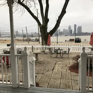 Front door view of patio seating area and Ohio River and Louisville skyline.