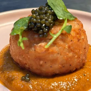 Arancini over black truffle calabrian chile tomato sauce, caviar and watercress