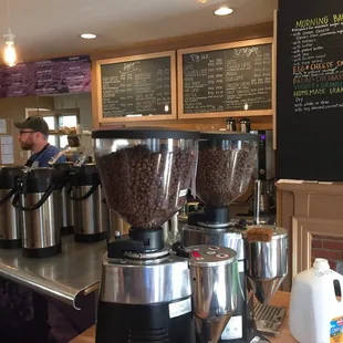 a coffee shop counter with coffee grinders
