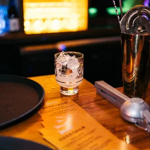 a shot of a glass of whiskey on a bar
