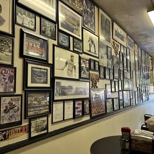 a wall of framed photos
