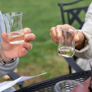 two people holding glasses of wine