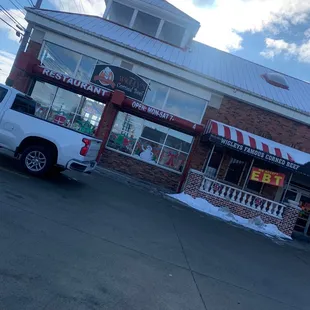 a truck parked in front of a restaurant