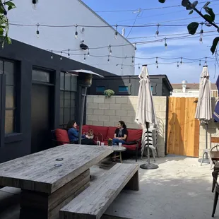 two people sitting at a table outside