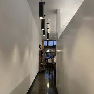 a long hallway with a table and chairs