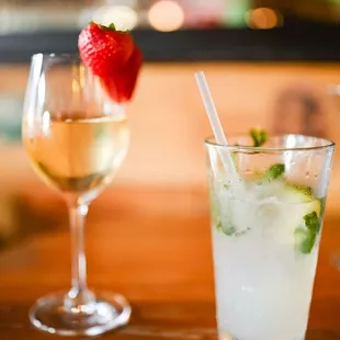 two glasses of wine and a strawberry