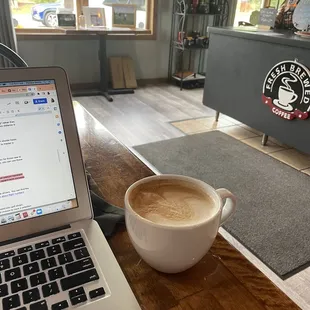 a cup of coffee and a laptop