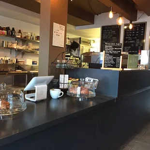 a counter with a coffee maker and cups on it