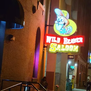 a neon sign for wild beaver saloon