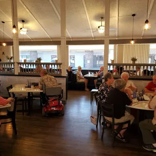 people sitting at tables in a restaurant