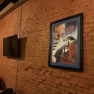 a poster on a brick wall