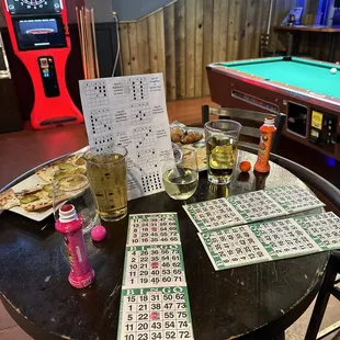 a table with a lottoons, beer, and a game