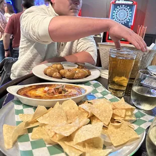 a man sitting at a table with plates of food