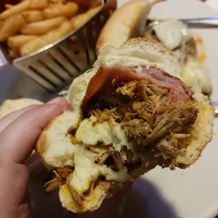 The perfect bite of Cuban (mustard, pickle, ham, pork)