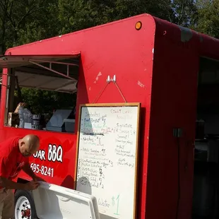 a man leaning on a food truck