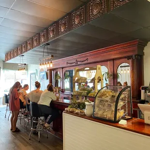 people sitting at a bar in a restaurant