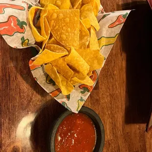 a bowl of salsa and tortilla chips