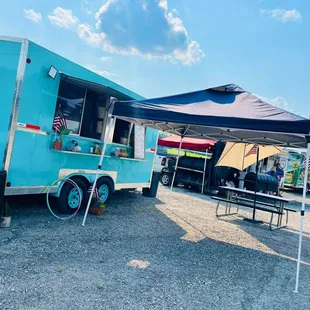 a blue food truck parked in a parking lot