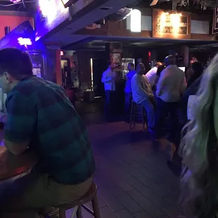 a group of people sitting at a bar