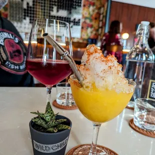 a glass of red wine and a glass of orange juice