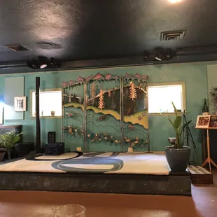 a room with a stage and a guitar