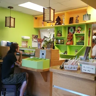 a man sitting at a desk in a store