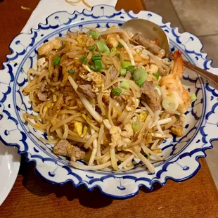 a blue and white bowl of food