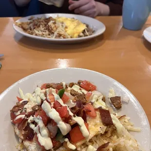 upper plate: hash browns and omelet  lower plate: el cabro