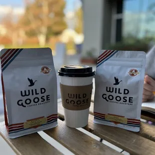 two coffee bags and a cup of coffee