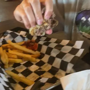 a person eating a burger and fries