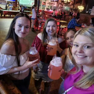 a group of women holding drinks
