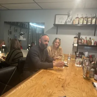 a group of people sitting at a bar