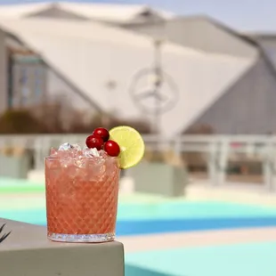 a cocktail with a cherry garnish