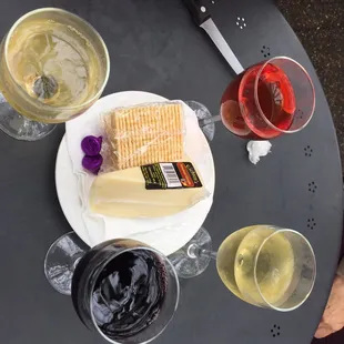 a table with wine, cheese and crackers