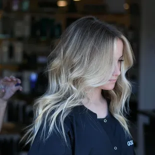 Money piece highlights and foilayage styled with flat iron waves.