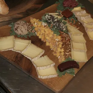 a variety of cheeses on a cutting board