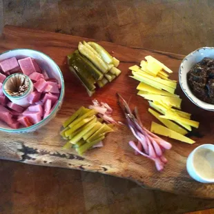 a wooden cutting board with a variety of food items