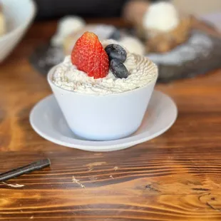 a bowl of oatmeal with berries on top