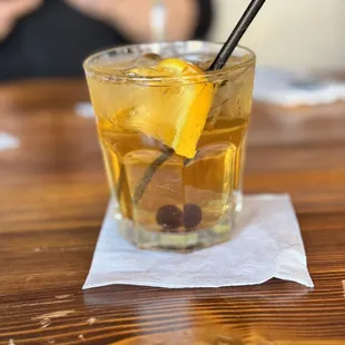 a glass of lemonade on a napkin