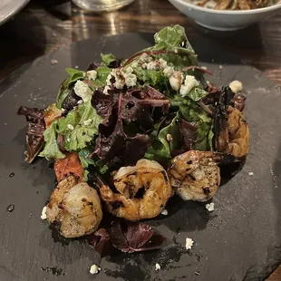 Green salad with grilled watermelon and shrimp.